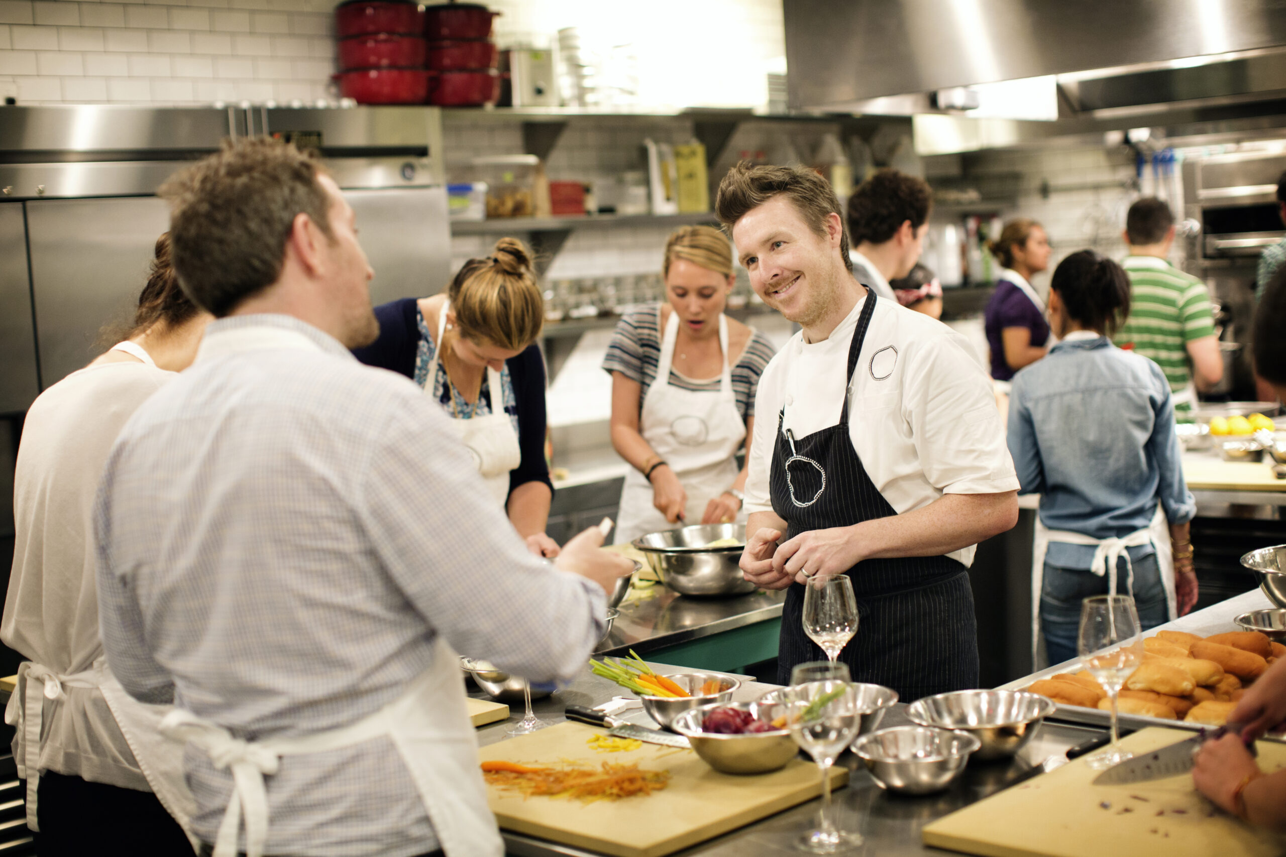 Chef Teaching Students At Commercial Kitchen